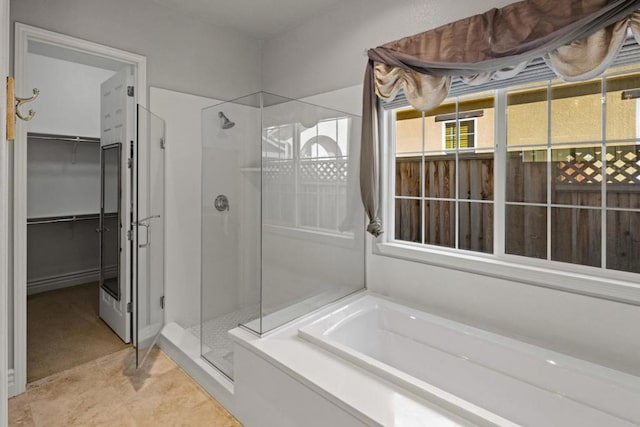 bathroom with independent shower and bath and tile patterned floors