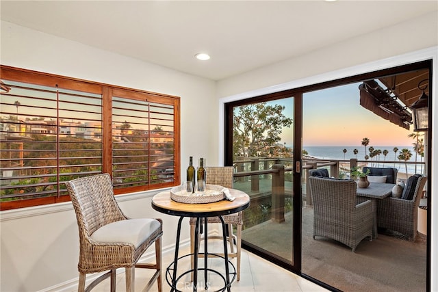 dining space featuring a water view