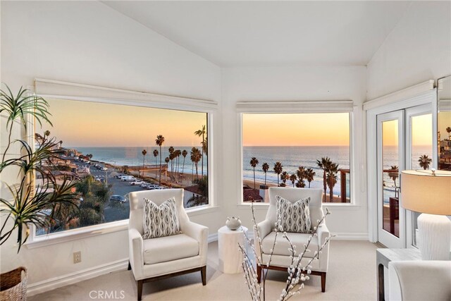 living area with carpet flooring, french doors, a water view, and vaulted ceiling