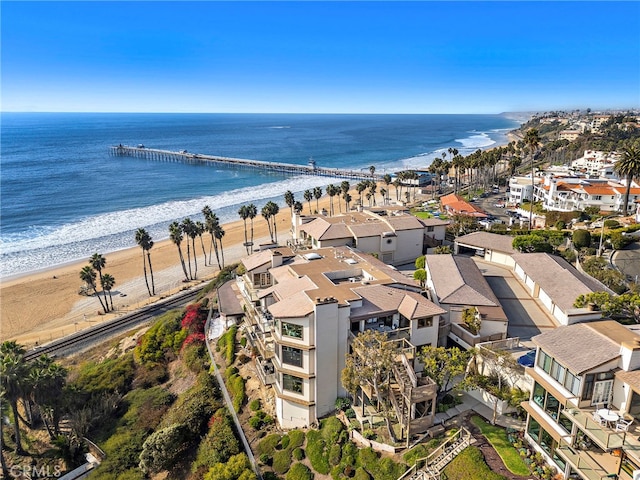 birds eye view of property featuring a water view and a beach view