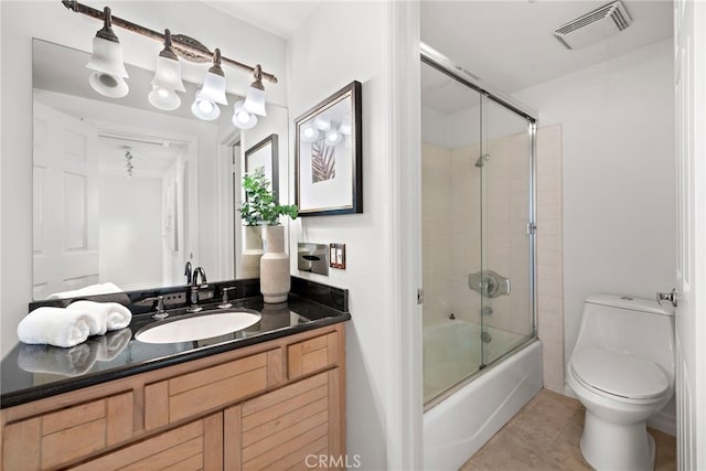 full bathroom featuring tile patterned flooring, enclosed tub / shower combo, vanity, and toilet