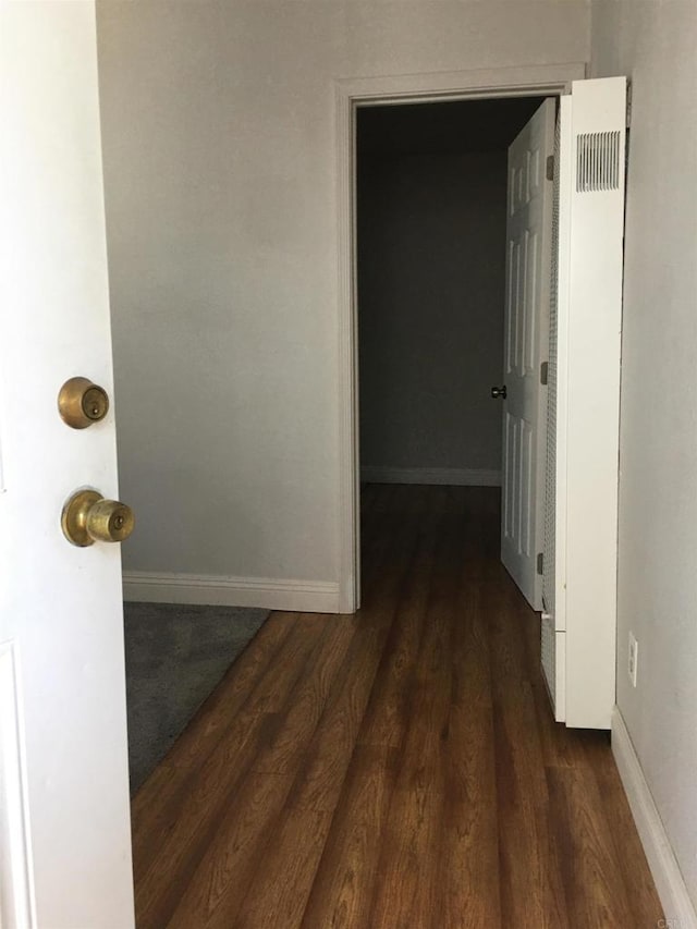 hall with dark hardwood / wood-style flooring