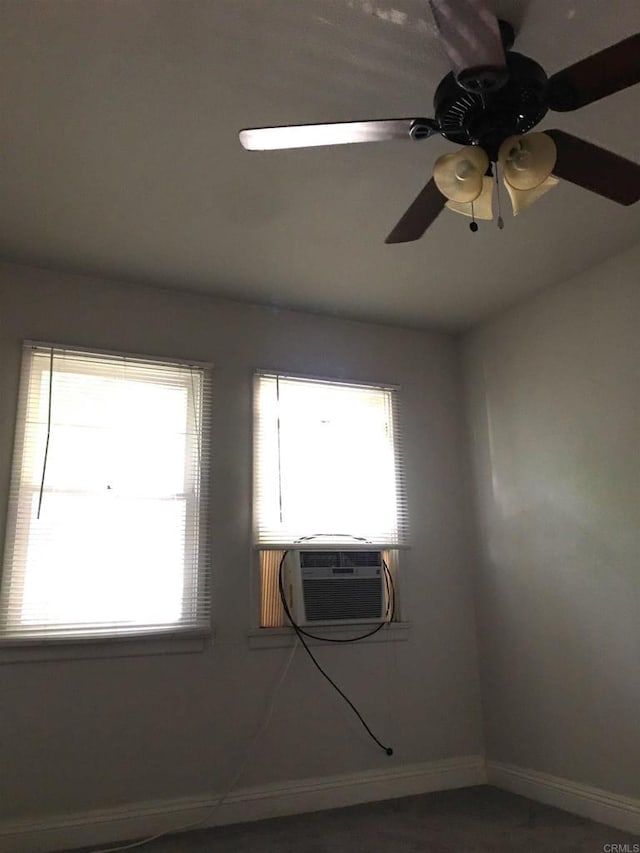 empty room featuring ceiling fan and cooling unit