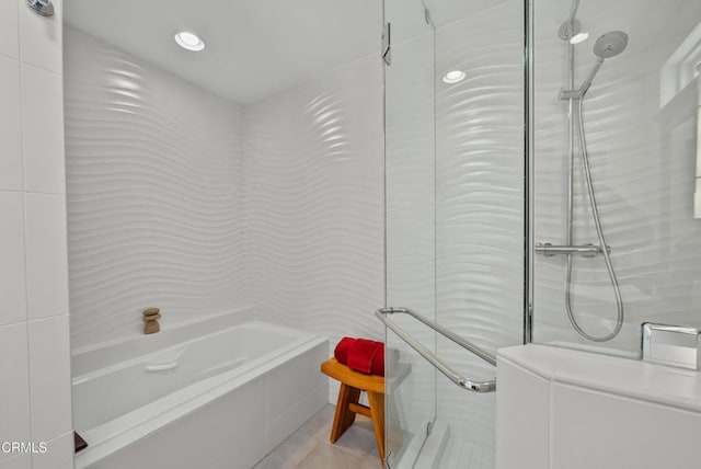 bathroom with separate shower and tub and tile patterned flooring