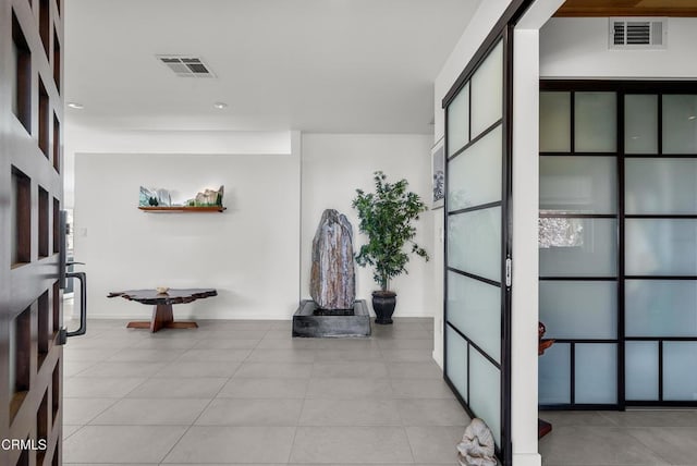 hall featuring light tile patterned flooring