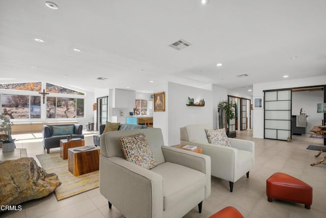 living room with sink, light tile patterned floors, and vaulted ceiling