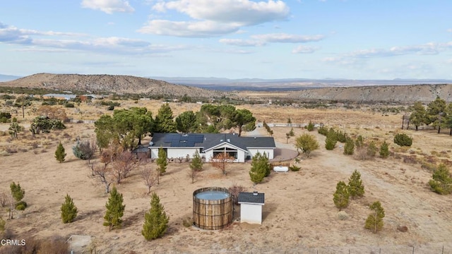 birds eye view of property featuring a mountain view and a rural view