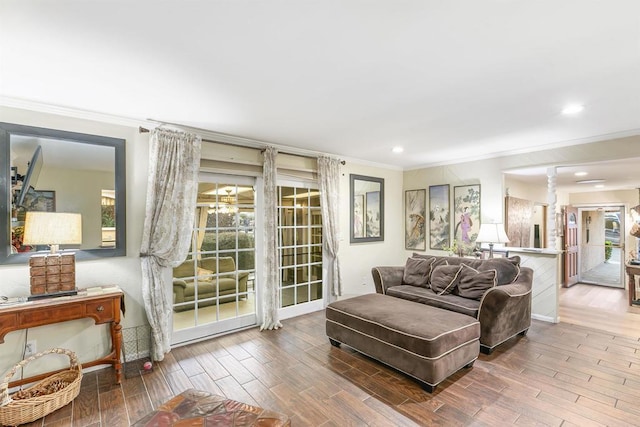 living room with hardwood / wood-style floors and crown molding