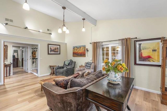 living room with beamed ceiling, a chandelier, high vaulted ceiling, and light hardwood / wood-style flooring