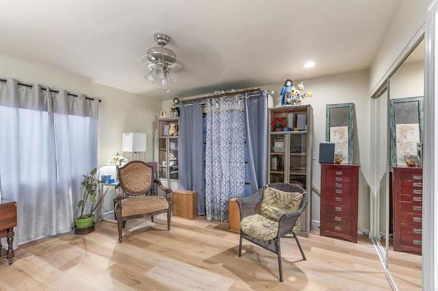 living area featuring ceiling fan and light wood-type flooring