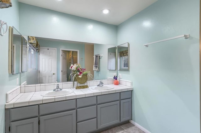 bathroom with tile patterned floors and vanity