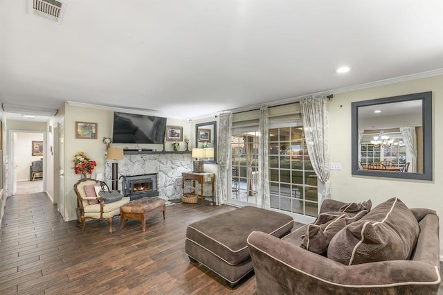 living room featuring a wood stove, crown molding, and wood-type flooring