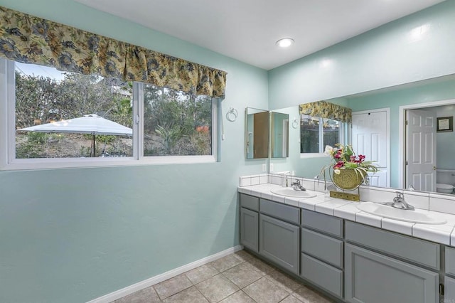 bathroom featuring tile patterned floors, vanity, and toilet