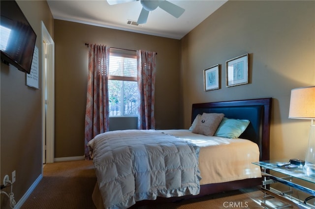 bedroom with ceiling fan and dark carpet