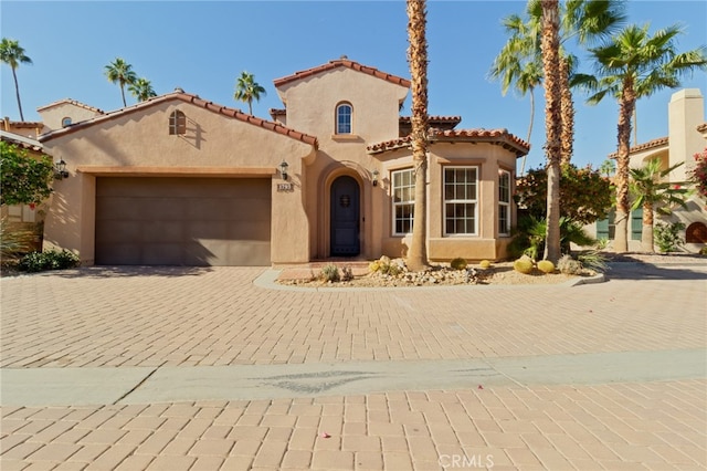 mediterranean / spanish-style house featuring a garage