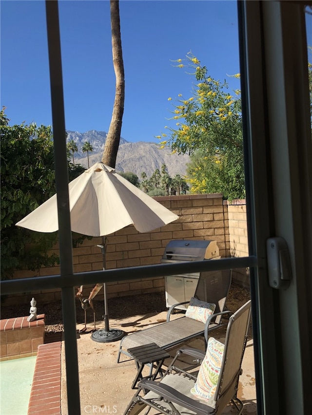 view of patio with a mountain view and grilling area