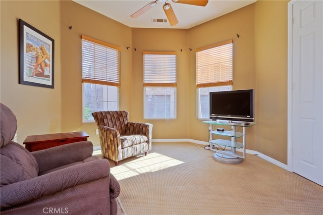 carpeted living room featuring ceiling fan