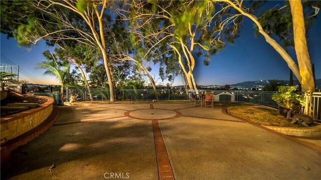 view of community featuring a mountain view and a patio