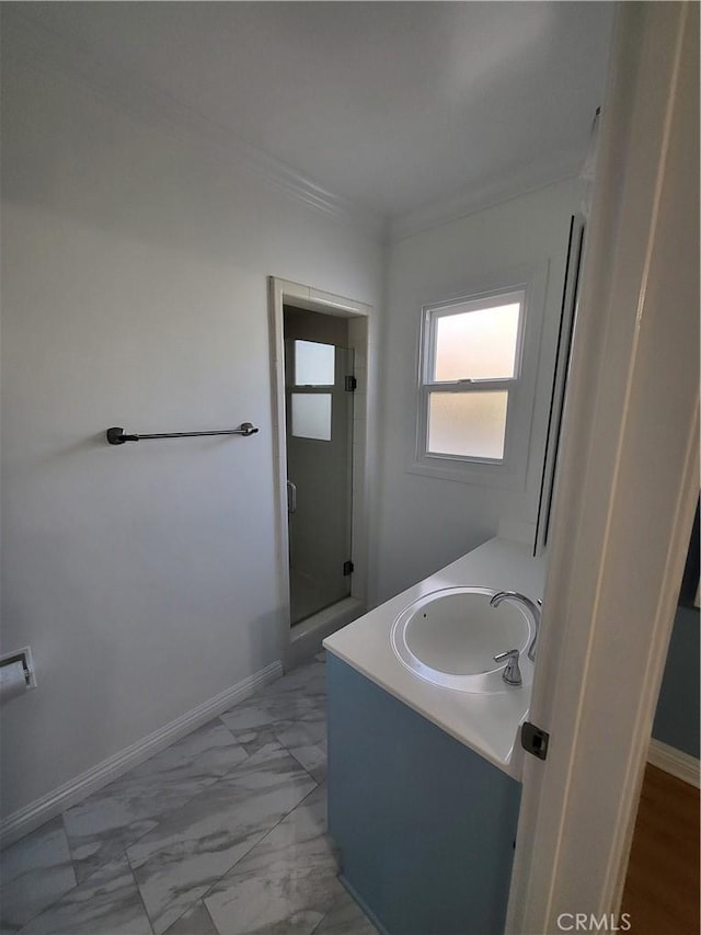 bathroom with vanity, crown molding, and walk in shower