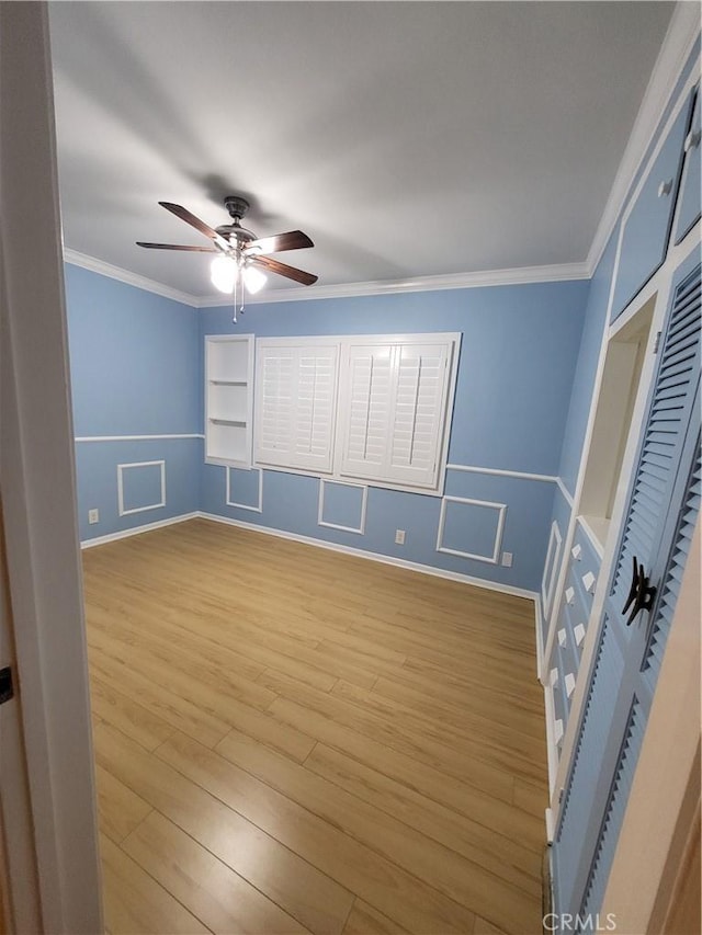 unfurnished bedroom with light hardwood / wood-style flooring, ceiling fan, and ornamental molding