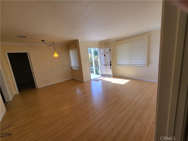 unfurnished room featuring light wood-type flooring and ornamental molding