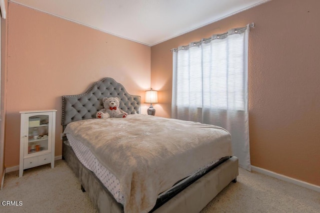 carpeted bedroom featuring ornamental molding