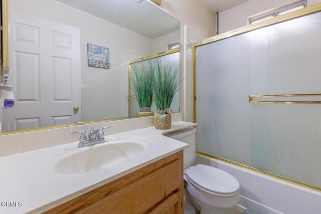 full bathroom with vanity, toilet, and enclosed tub / shower combo