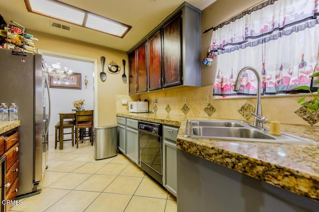 kitchen with stainless steel fridge, sink, a notable chandelier, black dishwasher, and light tile patterned flooring