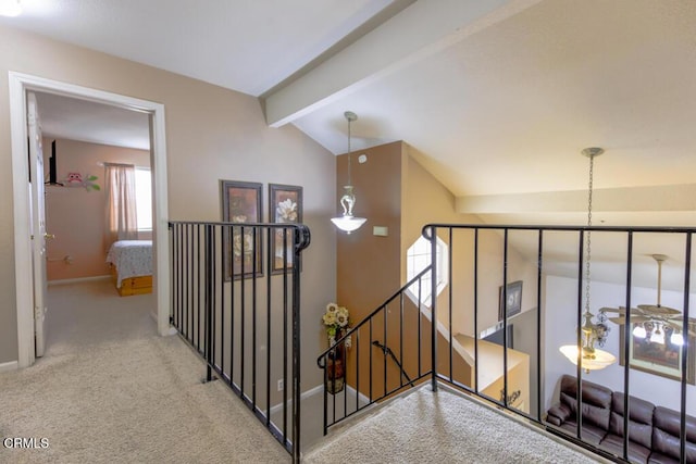 corridor with lofted ceiling with beams and light carpet