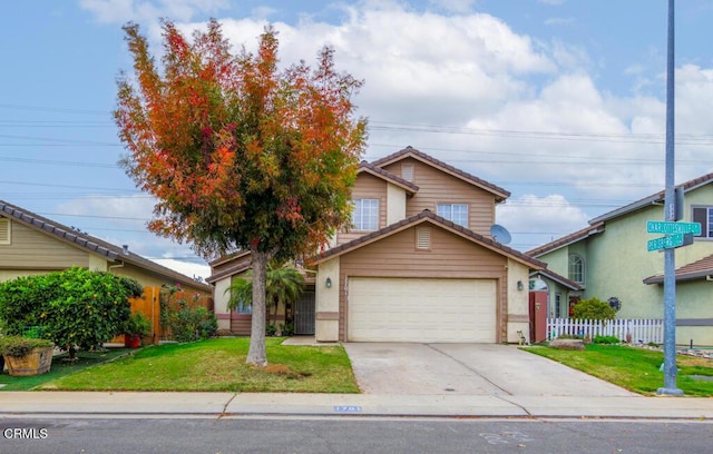 view of front of home with a front yard and a garage