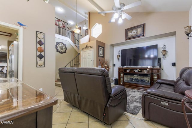 tiled living room featuring beam ceiling, high vaulted ceiling, and ceiling fan