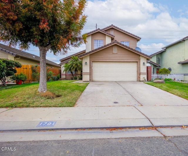 view of property featuring a front lawn and a garage