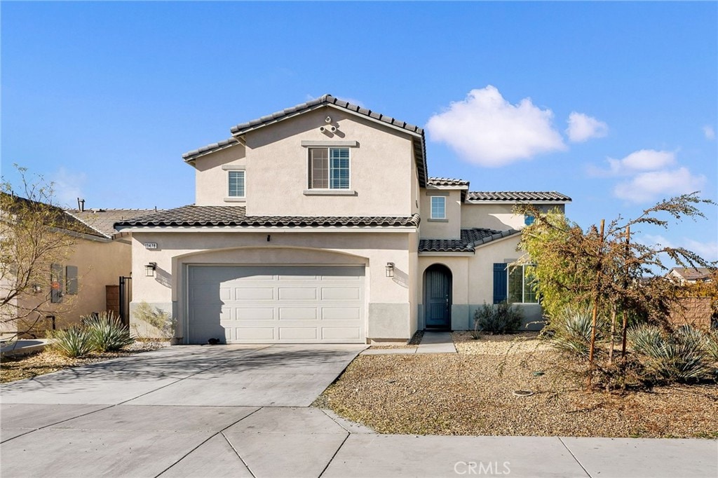 mediterranean / spanish home featuring a garage