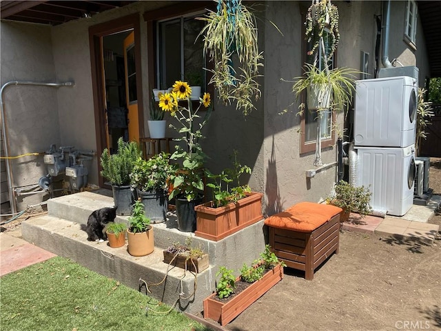 view of patio / terrace featuring stacked washer and clothes dryer