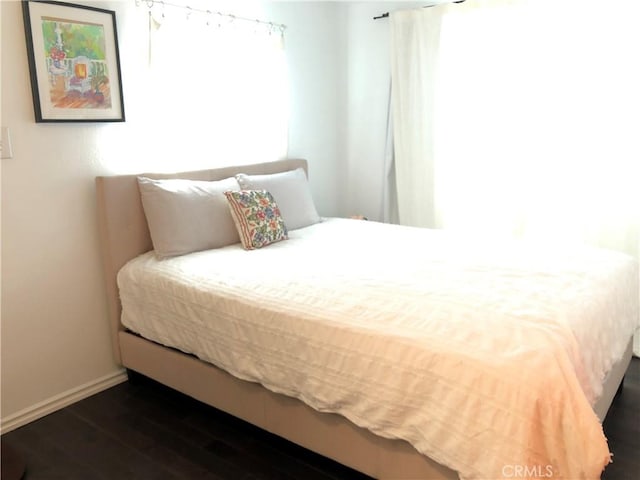 bedroom featuring dark hardwood / wood-style flooring