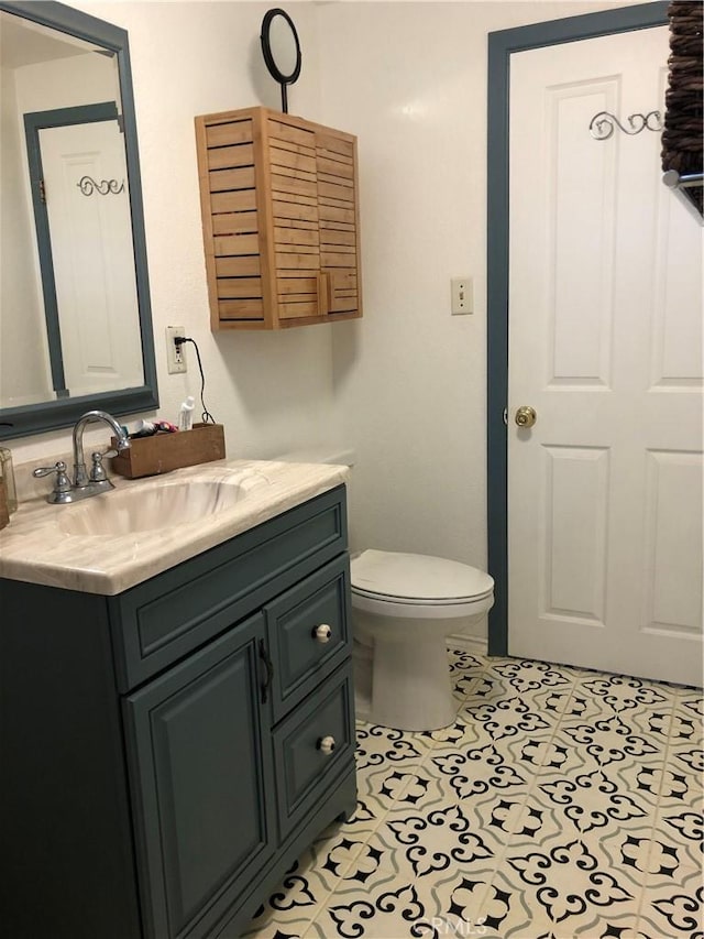 bathroom featuring tile patterned flooring, vanity, and toilet