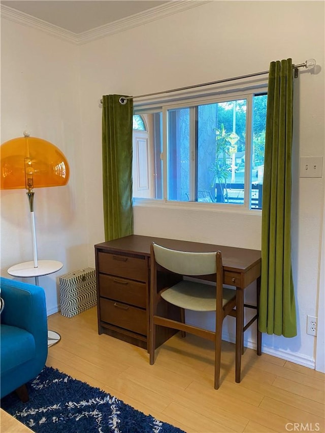 sitting room with crown molding and light hardwood / wood-style flooring