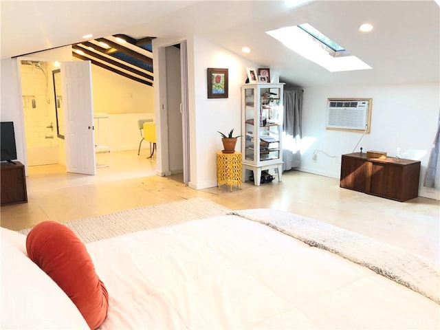 bedroom featuring vaulted ceiling with skylight, concrete floors, a wall unit AC, and ensuite bath