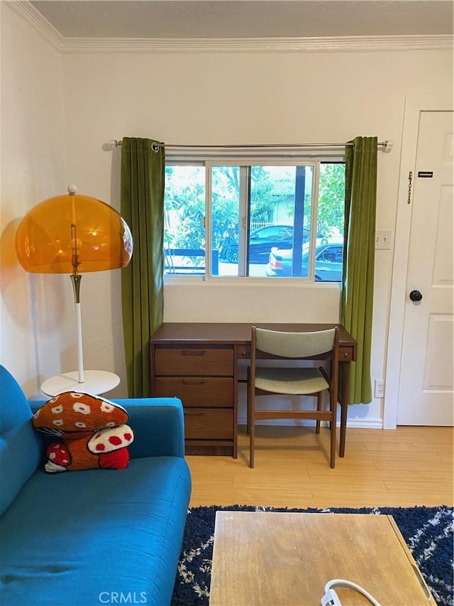 sitting room featuring light hardwood / wood-style floors and ornamental molding