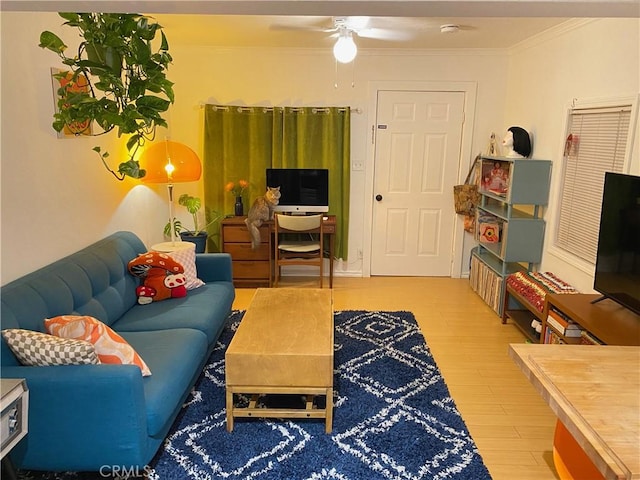 living room featuring hardwood / wood-style flooring, ceiling fan, and crown molding