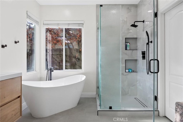 bathroom featuring shower with separate bathtub, vanity, and tile patterned floors