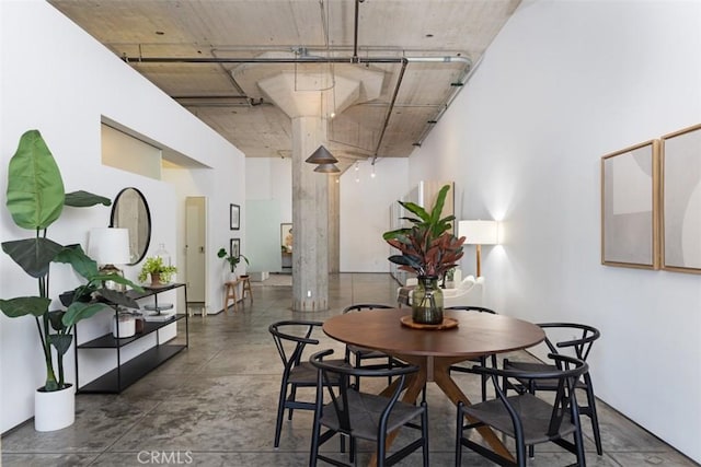 dining space featuring decorative columns