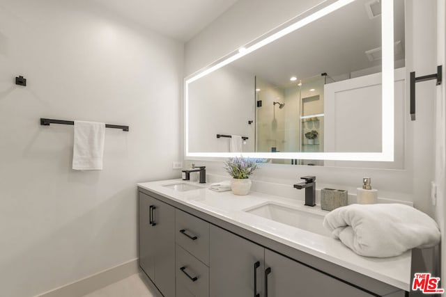 bathroom featuring vanity and a shower with door