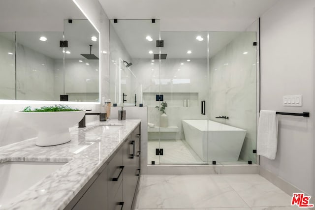 bathroom featuring vanity and independent shower and bath