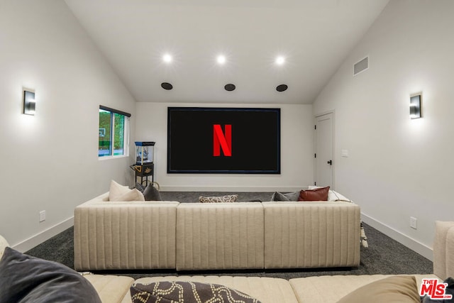 home theater room with carpet flooring and high vaulted ceiling