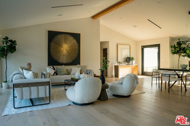 living room featuring beam ceiling, light hardwood / wood-style floors, and high vaulted ceiling