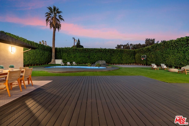 deck at dusk with a yard