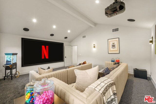 carpeted cinema room with lofted ceiling with beams