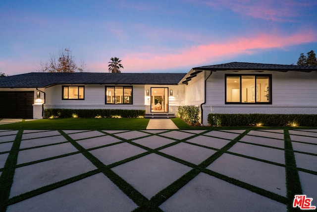 view of front facade with a garage and a lawn