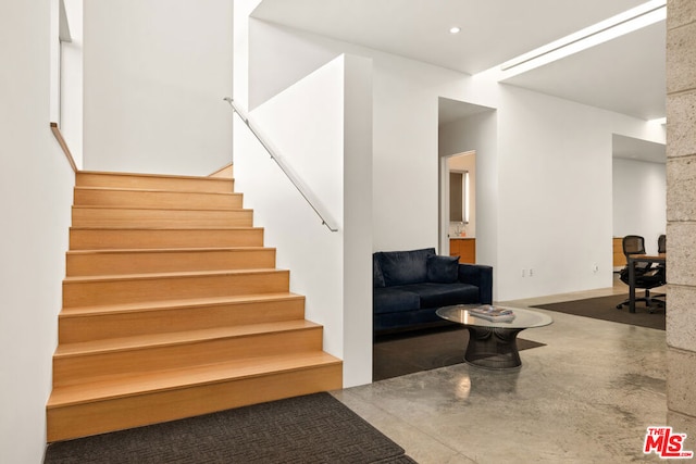 stairs with concrete floors